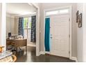 Inviting foyer featuring hardwood floors and view to a study with a stylish desk and blue patterned drapes at 367 Falling Water Rd, Spring Lake, NC 28390