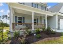 Charming front porch with wooden railing and landscaping at 830 Cypress Rd, Cameron, NC 28326