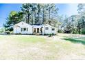 Inviting home featuring a classic white exterior and a beautifully maintained lawn at 2991 Rocky Fork Church Rd, Sanford, NC 27332
