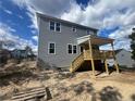 Gray house with a deck and stairs leading to the backyard at 114 Kingwood Dr, Lillington, NC 27546