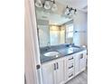 Bathroom with double vanity, granite countertop, and large mirror at 125 Shadybrook Dr, Benson, NC 27504