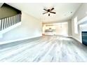 Spacious living room with hardwood floors and view into kitchen at 125 Shadybrook Dr, Benson, NC 27504