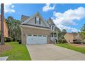 Two-story house with a three-car garage, and well-maintained lawn at 738 N Micahs Way, Spring Lake, NC 28390