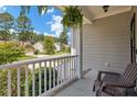 Relaxing front porch with white railing, offering a view of the neighborhood at 738 N Micahs Way, Spring Lake, NC 28390