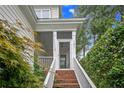 Inviting front porch with brick steps and white railings leading to the front door at 197 Lamplighter Way, Spring Lake, NC 28390