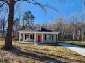 Newly built gray house with red door and a spacious yard at 910 West St, Smithfield, NC 27577