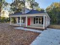 Newly built home with a gray exterior, red door, and porch at 910 West St, Smithfield, NC 27577