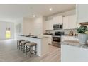 Modern kitchen with stainless steel appliances, granite countertops, and an island with seating at 903 Windrace Trl, Sanford, NC 27332