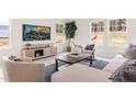 Bright living room featuring a neutral color palette, comfortable seating, and large windows at 903 Windrace Trl, Sanford, NC 27332