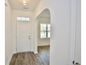 Bright entryway with wooden floors and a decorative archway at 2885 Lemuel Black Rd, Bunnlevel, NC 28323