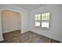 Well lit living room featuring stylish wood-look flooring and white trim at 2885 Lemuel Black Rd, Bunnlevel, NC 28323