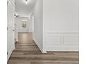 Inviting hallway featuring elegant trim work, light gray walls, and beautiful light brown vinyl flooring at 732 Burley Oak Dr, Cameron, NC 28326