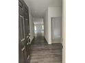 Open entryway featuring durable dark wood-look flooring and a view into the living spaces at 8022 Royal Dr, Sanford, NC 27332