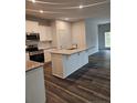 Modern kitchen boasts a spacious island, stainless steel appliances, and an open layout at 8022 Royal Dr, Sanford, NC 27332