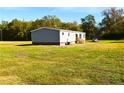 A view of the side of the single-story home with ample yard space at 16 Industrial Dr, Bunnlevel, NC 28323