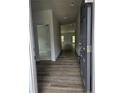 Inviting foyer with wood-look flooring, leading into the home's open floor plan, and neutral color scheme at 8026 Royal Dr, Sanford, NC 27332
