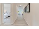 Inviting hallway with wood floors connecting the bedroom and living area at 8027 Royal Dr, Sanford, NC 27332