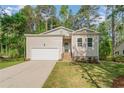 Charming home featuring a one-car garage, manicured lawn, and inviting front entrance at 8030 Turnberry Cir, Sanford, NC 27332