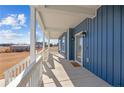 Spacious front porch with white railings, blue siding, and a view of the yard at 5554 Lake Vista Ct, Rocky Mount, NC 27803