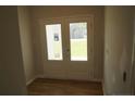 Bright entryway featuring double doors and wood flooring at 123 Nectar Ln, Bunnlevel, NC 28323