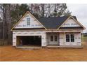 New construction home showcasing a classic design and two-car garage at 123 Nectar Ln, Bunnlevel, NC 28323