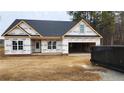 New construction home with gray roof, attached garage, and dumpster at 137 Nectar Ln, Bunnlevel, NC 28323