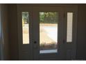 A bright, white front door with sidelights and a transom window welcomes you home at 154 Nectar Ln, Bunnlevel, NC 28323