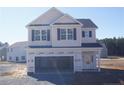 Newly constructed two-story home with a two-car garage at 154 Nectar Ln, Bunnlevel, NC 28323