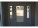 Modern front door with sidelights and clear glass panels at 154 Nectar Ln, Bunnlevel, NC 28323