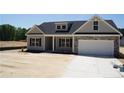 Attractive single-story home with a stone-accented facade and well-manicured lawn at 174 Nectar Ln, Bunnlevel, NC 28323