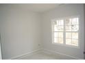 A sunlit room showcasing a large window and neutral wall paint at 174 Nectar Ln, Bunnlevel, NC 28323