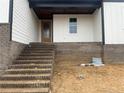 Exterior view of the home's entrance, featuring a brick stairway and a covered porch at 196 Hook Dr, Fuquay Varina, NC 27526