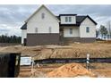 Two-story home with white siding, brick accents, and a covered porch at 196 Hook Dr, Fuquay Varina, NC 27526