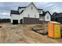 Rear view of two-story home with white siding and brick accents at 196 Hook Dr, Fuquay Varina, NC 27526