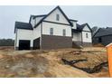 Exterior view of a two-story home with white siding, black accents, and an attached garage at 196 Hook Dr, Fuquay Varina, NC 27526