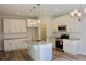 Contemporary kitchen with granite countertops, stainless steel appliances, and ample cabinet space at 59 Mossy Bridge Ct, Lillington, NC 27546