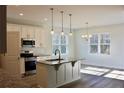 Modern kitchen features granite countertops, stainless steel appliances, and a functional island at 59 Mossy Bridge Ct, Lillington, NC 27546