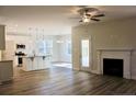 Open-concept living space featuring hardwood floors, fireplace, and seamless flow to the modern kitchen at 59 Mossy Bridge Ct, Lillington, NC 27546