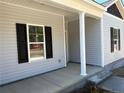 Close up of front entry and covered porch with white pillars and gray vinyl siding at 4983 (Lot 3) Ray Rd, Spring Lake, NC 28390