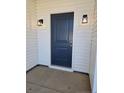 Entryway featuring a blue front door framed by sconces and white siding at 102 Onslow Ct, Spring Lake, NC 28390