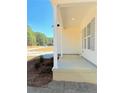 Inviting front porch with classic white columns and a view of the landscaped front yard at 5011 (Lot 5) Ray Rd, Spring Lake, NC 28390