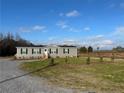 Gray manufactured home on a large lot with spacious yard at 441 Hayes Rd, Spring Lake, NC 28390