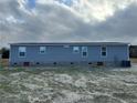 Back of the house, showing gray siding and a flat yard at 441 Hayes Rd, Spring Lake, NC 28390