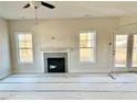 Bright living room featuring a fireplace and access to the backyard at 60 Bennett Rd, Coats, NC 27521