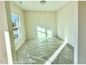 Bright, carpeted bedroom featuring natural light from a large window and neutral walls at 78 Bennett Rd, Coats, NC 27521