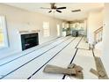 Open living room with fireplace and view into the kitchen area at 78 Bennett Rd, Coats, NC 27521