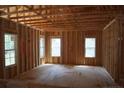 Unfinished living room featuring wood frame construction, large windows, and an open floor plan at 2194 Cleveland Cir, Sanford, NC 27332