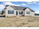 One-story house; beige vinyl siding, gray roof, and attached garage at 52 Roll Tide Ct, Angier, NC 27501