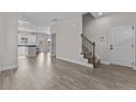 Bright and spacious entryway with hardwood floors, staircase, and view into the kitchen at 1264 Hayes Rd, Spring Lake, NC 28390