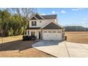 Two-story house with gray and white siding, two-car garage, and landscaped yard at 1264 Hayes Rd, Spring Lake, NC 28390